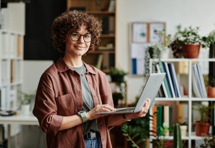 SaaS business owner reviewing embedded finance options on her laptop in her office