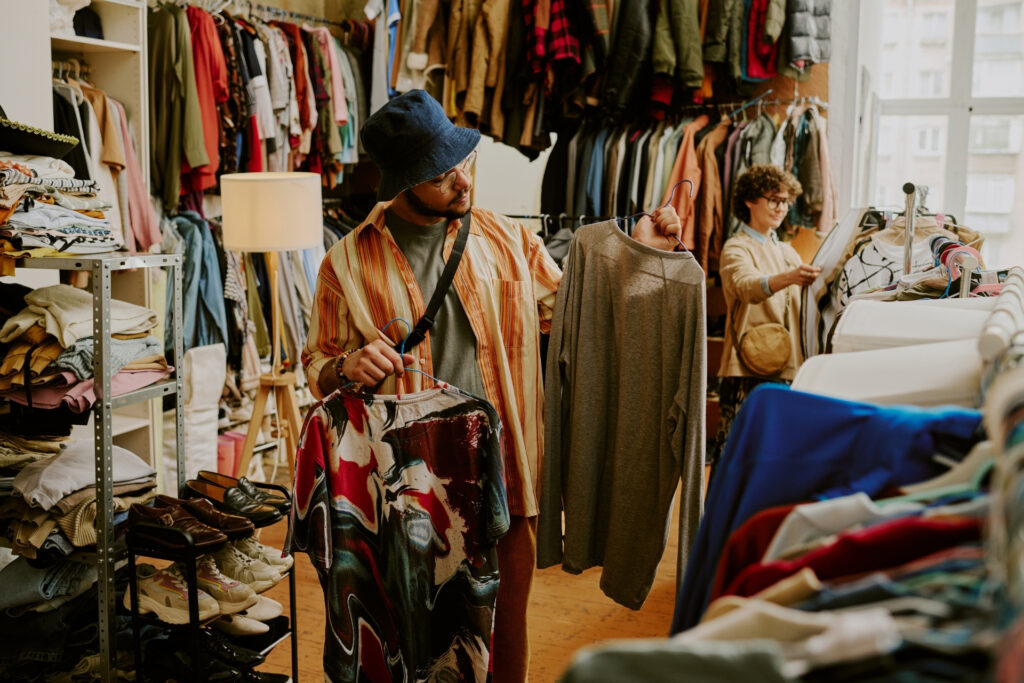 How to Accept Contactless Payments: A Guide for Growing Businesses 17 Man at resale store about to use contactless payments to purchase his clothes