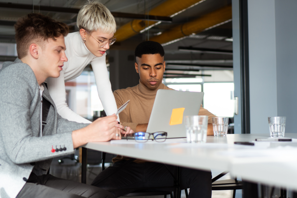 Small business team reviewing no-fee credit card processing options on a laptop in their office