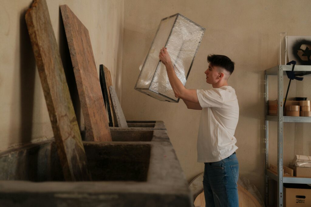 Home services contractor inspecting a component in a workshop, representing field service businesses that can use payment links to get paid faster after completing a job
