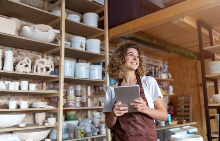 A small business owner uses merchant services from Flute to manage her pottery studio.