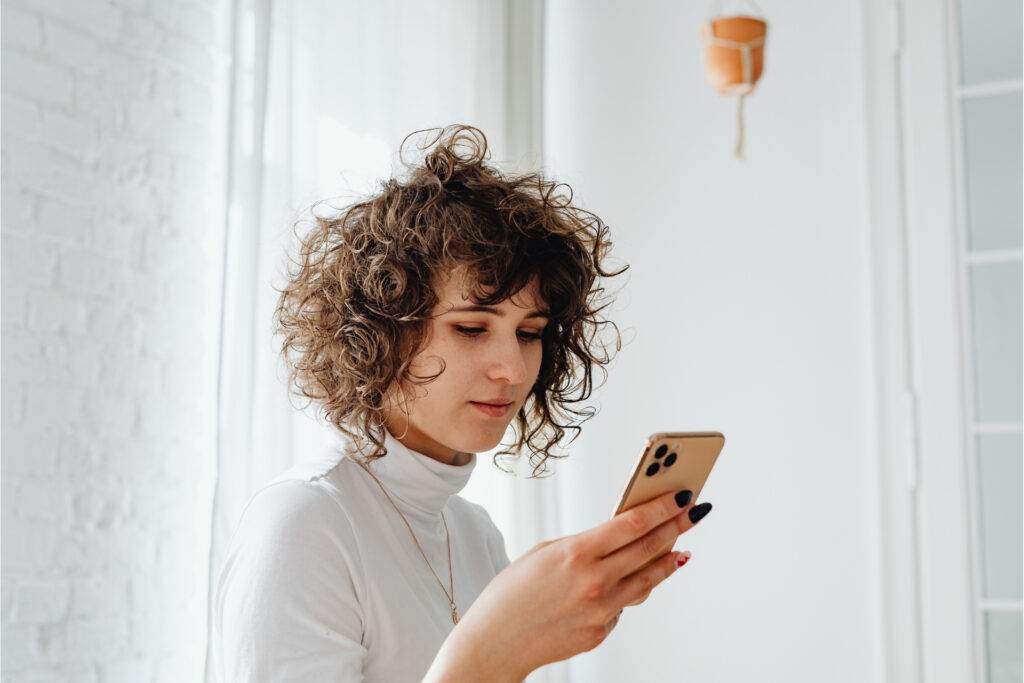 ACH Payments 101: A Small Business Guide to Bank Transfers 1 Small business owner sending an ACH payment from her phone to move money between bank accounts