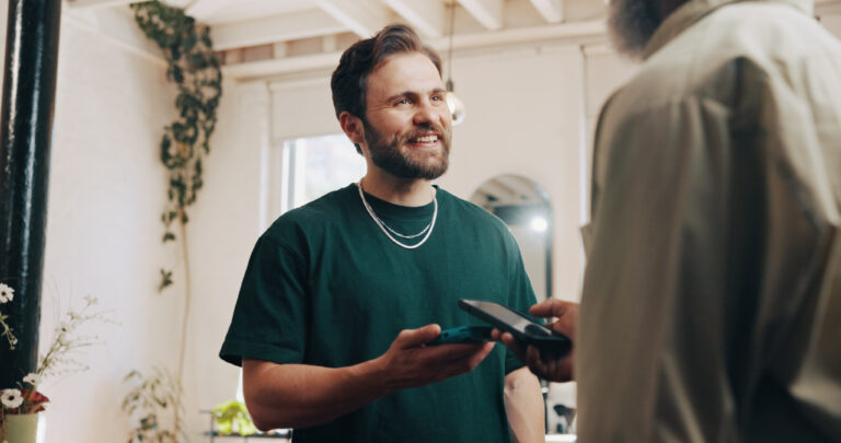 Hairdresser or customer with pos machine or phone for payment or banking app in salon. Male people, barber or client with mobile smartphone for tap to pay or wireless transaction in parlor.
