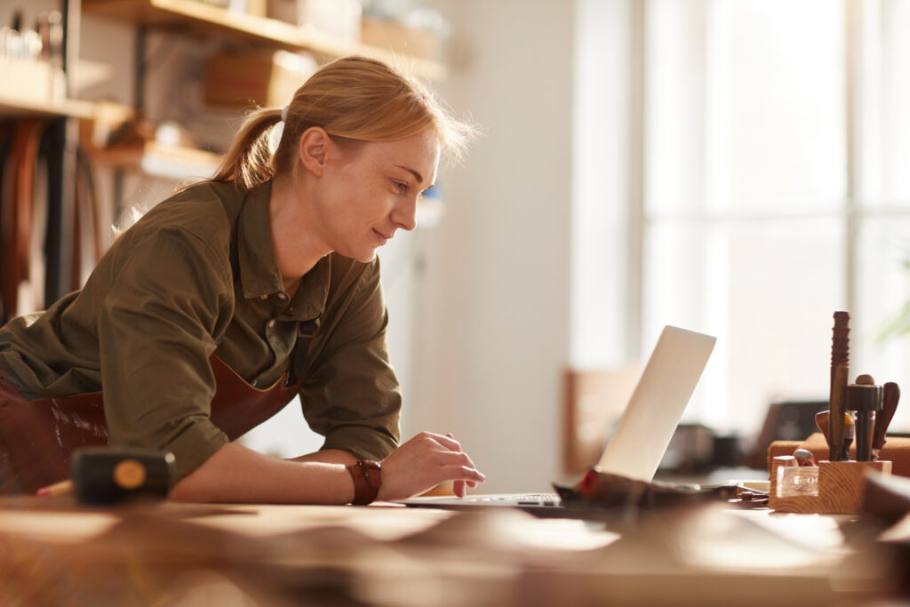 What Is Network Tokenization? A Guide to Safer, Smoother Payments 1 A leather goods maker checks her business's online payments from a laptop in her workshop.