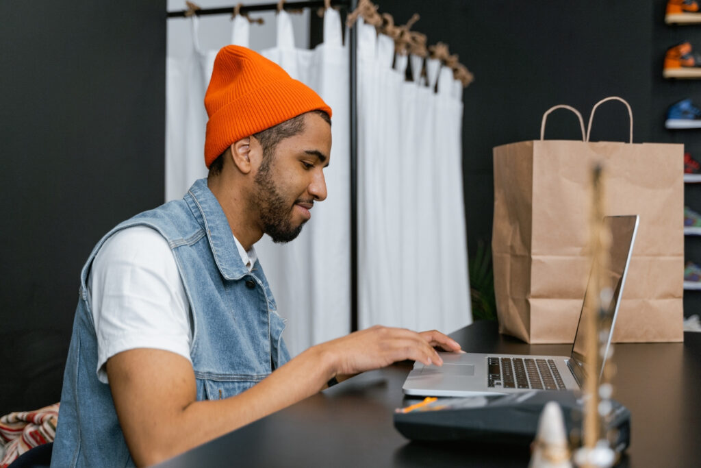 What Is a Hosted Payment Page? How It Works and Why It Matters 2 A small business owner reviews online orders on the laptop he uses to manage his store's hosted checkout page.