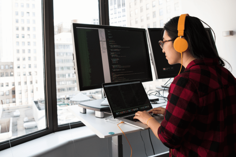 Software developer reviewing AI-generated code on dual monitors, part of an agentic engineering workflow